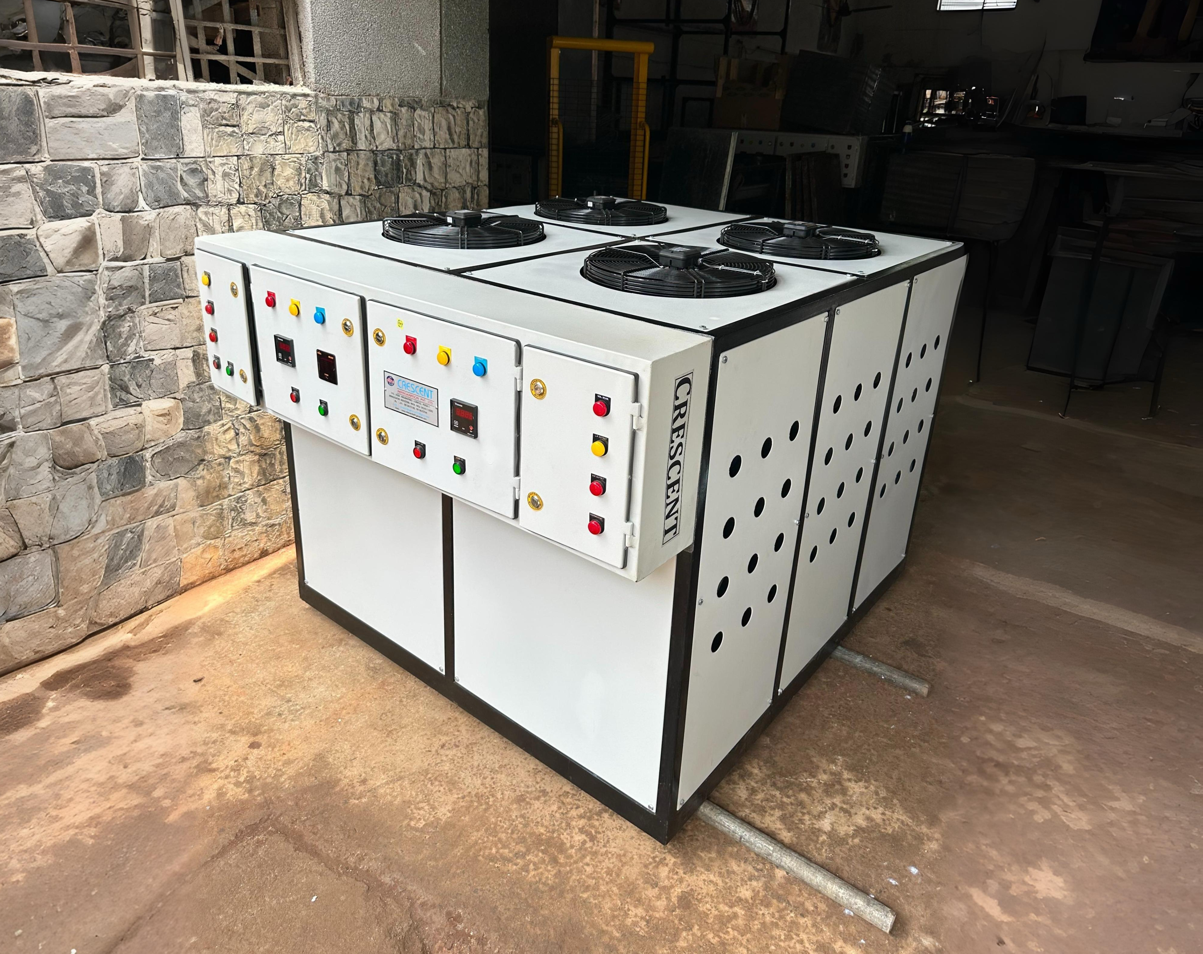 Technician inspecting industrial chiller machinery