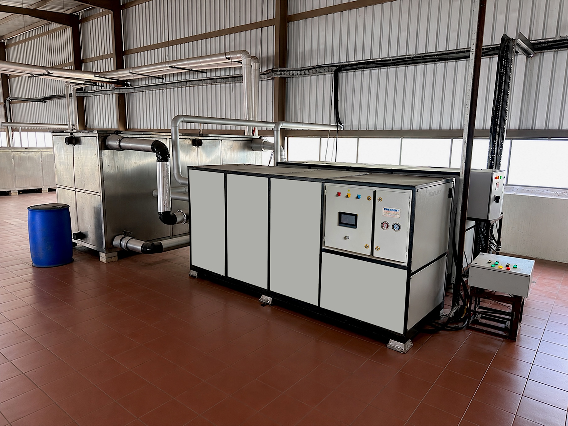 Industrial chiller plant room with pipes and machinery